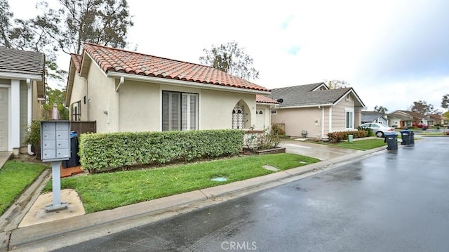 mediterranean / spanish-style home with stucco siding and a tiled roof