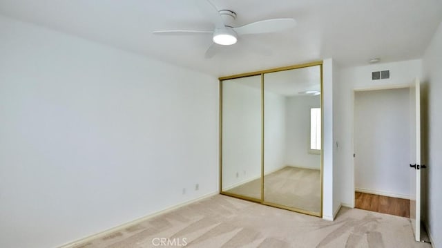 unfurnished bedroom with visible vents, ceiling fan, baseboards, carpet floors, and a closet