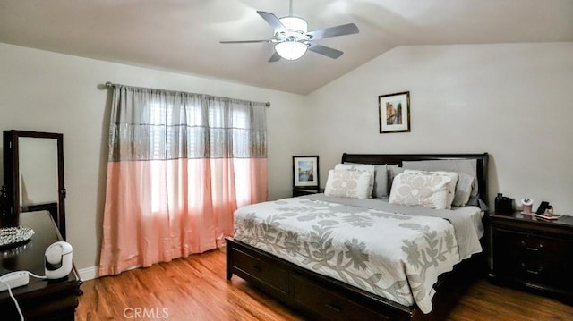 bedroom with wood finished floors, a ceiling fan, and vaulted ceiling