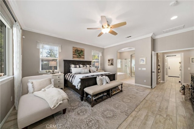 bedroom featuring arched walkways, ornamental molding, light wood-style flooring, and baseboards