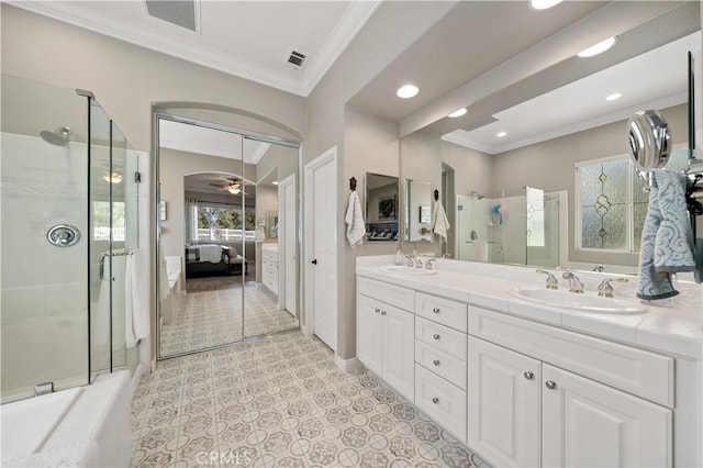 ensuite bathroom with crown molding, a stall shower, a sink, and connected bathroom