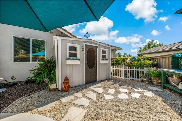 view of shed with fence