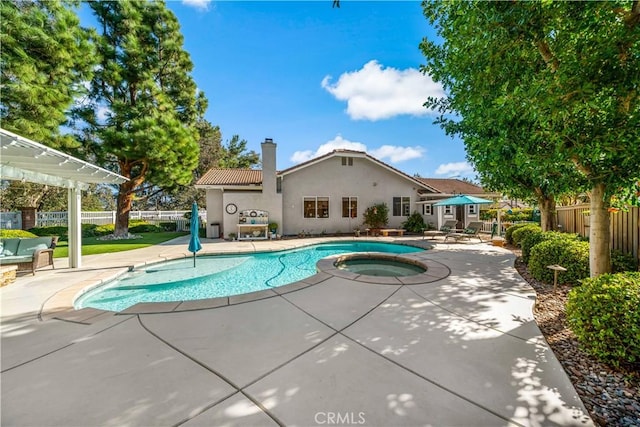 view of pool with a fenced in pool, fence, a patio, and an in ground hot tub