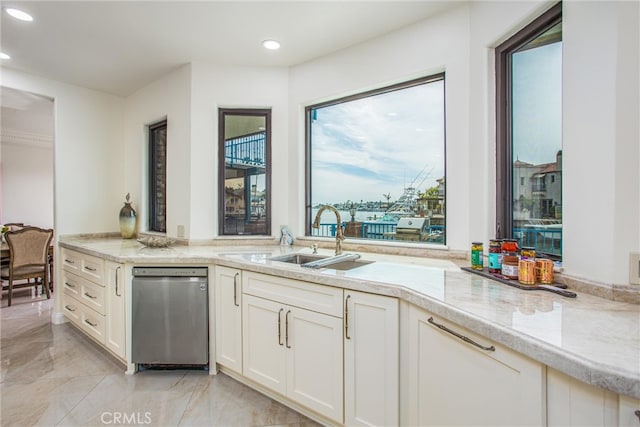 kitchen with recessed lighting, white cabinets, light countertops, and a sink