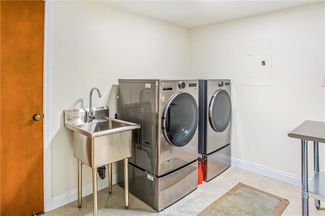 laundry area with laundry area, independent washer and dryer, electric panel, and baseboards