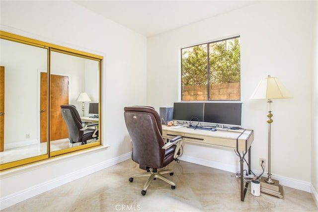 office area featuring baseboards and tile patterned floors