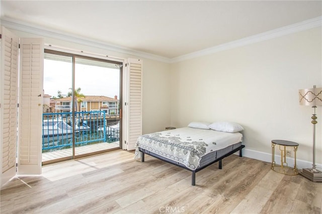 bedroom with baseboards, access to outside, light wood-type flooring, and crown molding