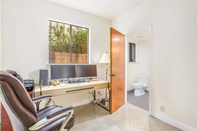 office with tile patterned floors and baseboards