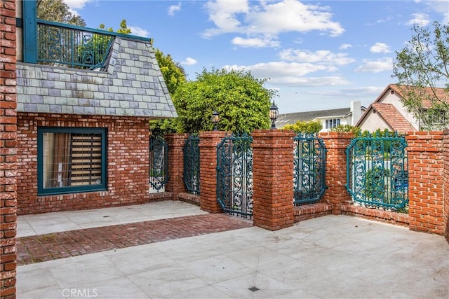 view of gate with fence