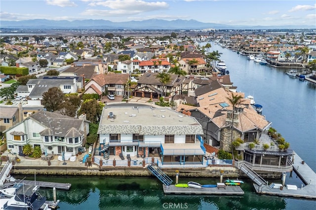 aerial view featuring a water and mountain view and a residential view