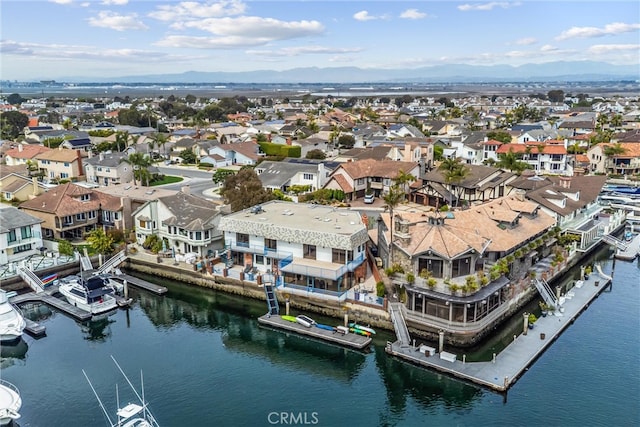 birds eye view of property with a water and mountain view and a residential view