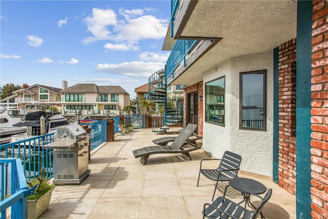 view of patio / terrace featuring a balcony and a residential view