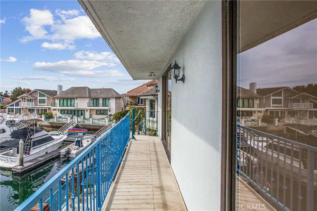 balcony with a water view and a residential view