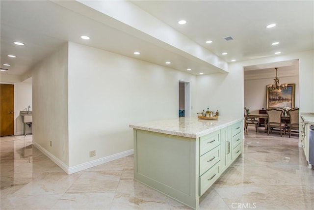 kitchen with light stone counters, marble finish floor, recessed lighting, green cabinetry, and baseboards