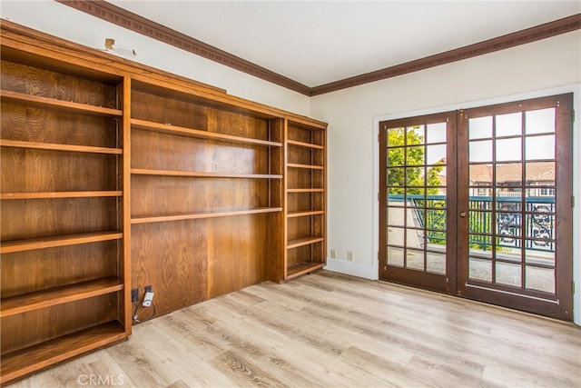 unfurnished room with french doors, crown molding, and wood finished floors