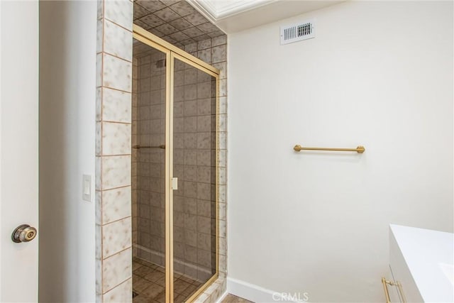 full bath featuring a shower stall, visible vents, and baseboards