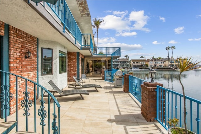 balcony featuring a water view and a patio