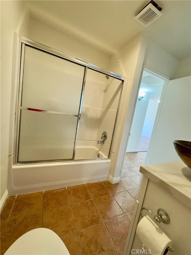 full bathroom with enclosed tub / shower combo, toilet, visible vents, baseboards, and tile patterned floors