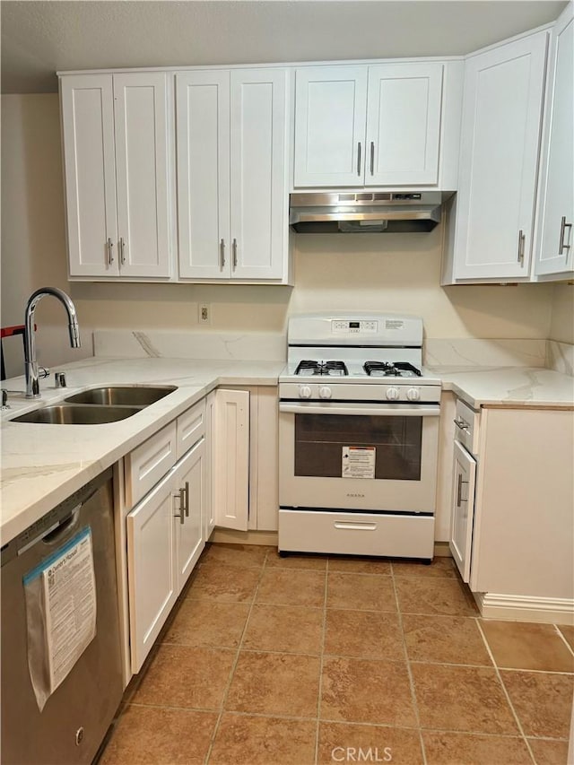 kitchen with white gas stove, stainless steel dishwasher, white cabinetry, a sink, and under cabinet range hood