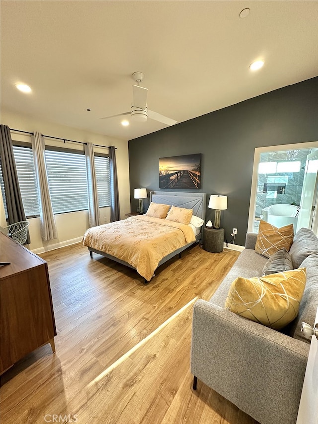 bedroom with a ceiling fan, lofted ceiling, baseboards, and light wood finished floors