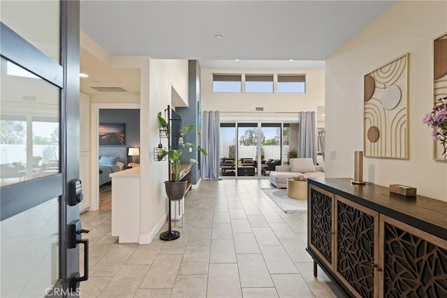 foyer entrance with recessed lighting and light tile patterned flooring