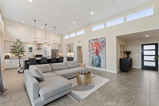 living room featuring recessed lighting and a high ceiling