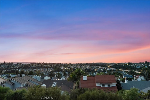 aerial view at dusk featuring a residential view