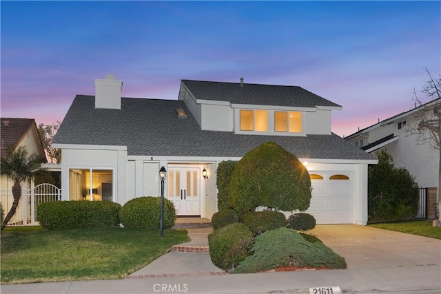 view of front of home featuring a garage, a shingled roof, driveway, a lawn, and a chimney