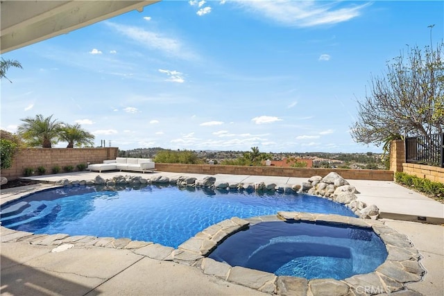 view of swimming pool featuring a fenced in pool, a patio area, a fenced backyard, and an in ground hot tub