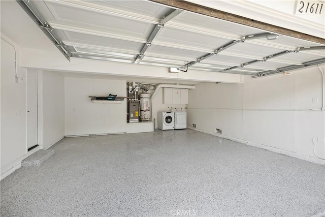 garage with washer and dryer and a garage door opener