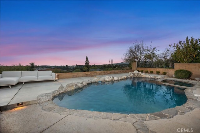 pool at dusk featuring fence, an outdoor living space, a fenced in pool, and a patio