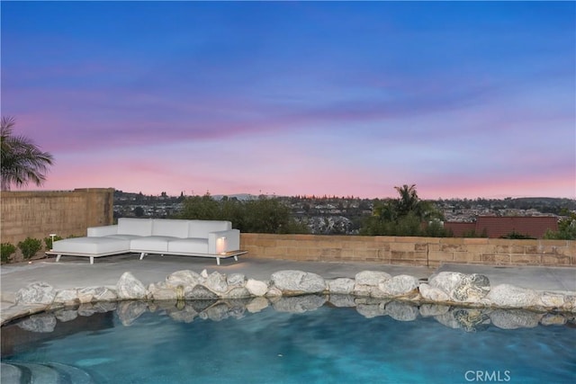 view of swimming pool featuring a patio area and fence