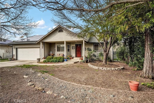 ranch-style home with solar panels, driveway, and an attached garage