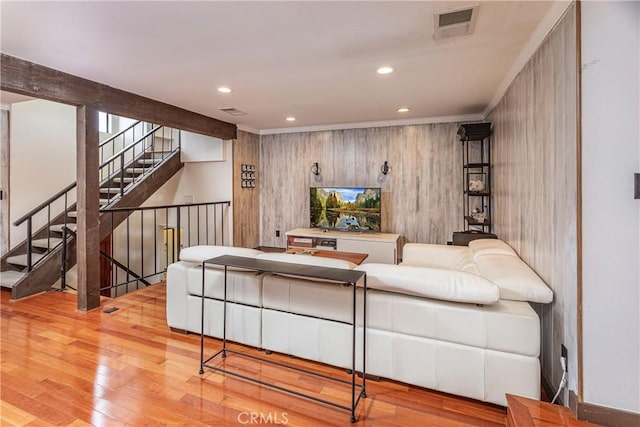 living area with stairs, wood finished floors, visible vents, and recessed lighting