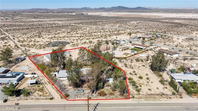 drone / aerial view featuring a desert view, a rural view, and a mountain view