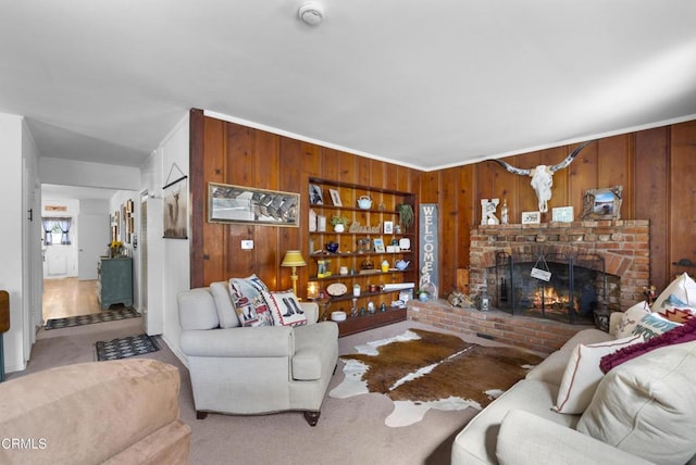 living room featuring built in features, a brick fireplace, carpet flooring, and wooden walls