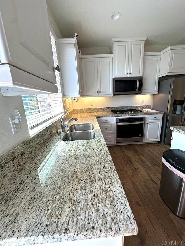 kitchen with white cabinets, stainless steel appliances, a healthy amount of sunlight, and a sink