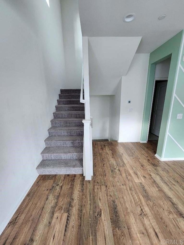 stairway with wood finished floors