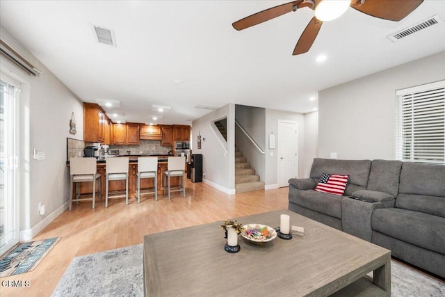 2438 Captains Walk, Bradley, CA 93426 - living area featuring light wood-style floors, stairway, a ceiling fan, and recessed lighting
