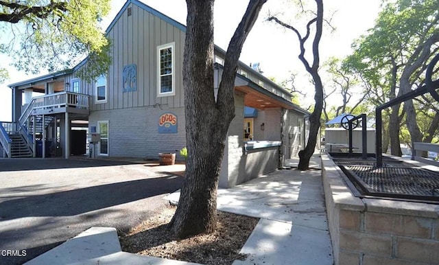 2438 Captains Walk, Bradley, CA 93426 - view of home's exterior featuring board and batten siding, stairs, and brick siding