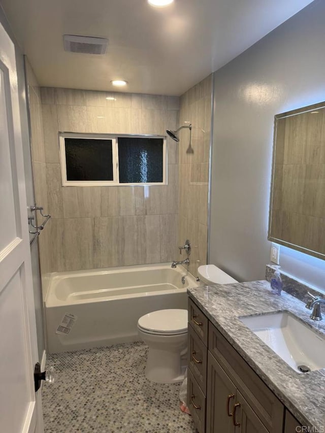 bathroom featuring tub / shower combination, toilet, and vanity