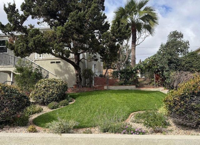 view of yard with stairs and fence