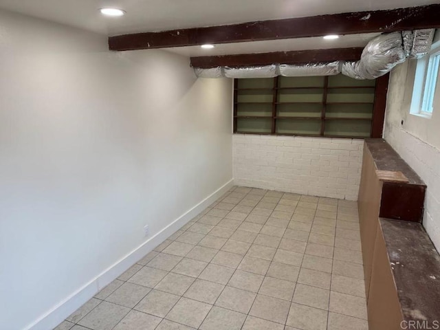 basement featuring recessed lighting, baseboards, and light tile patterned flooring