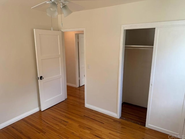 unfurnished bedroom featuring a closet, baseboards, and wood finished floors