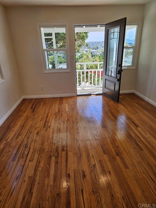 foyer featuring baseboards and hardwood / wood-style floors