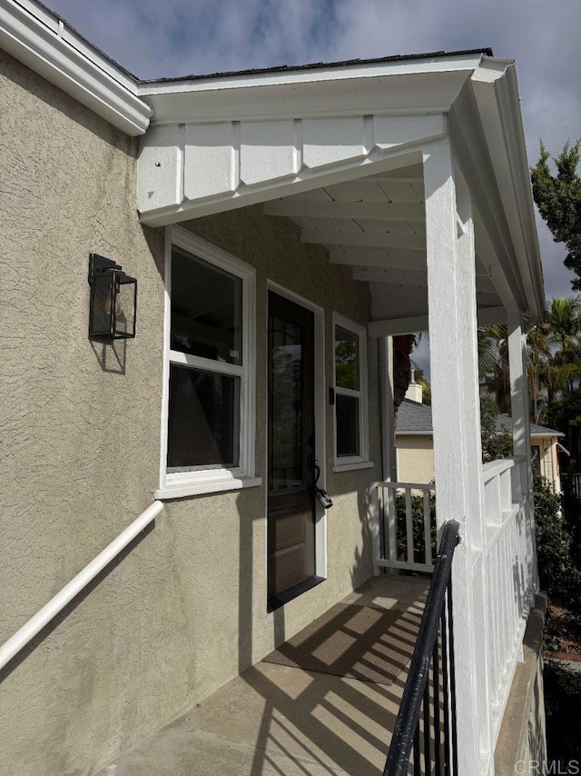 doorway to property featuring stucco siding