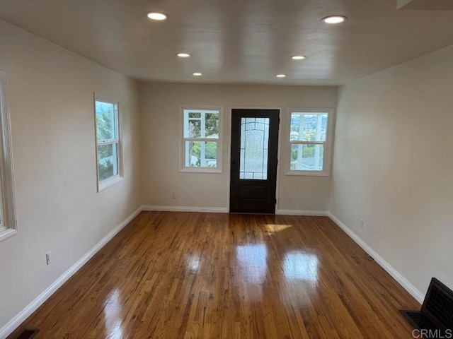 entrance foyer featuring hardwood / wood-style flooring, recessed lighting, visible vents, and baseboards