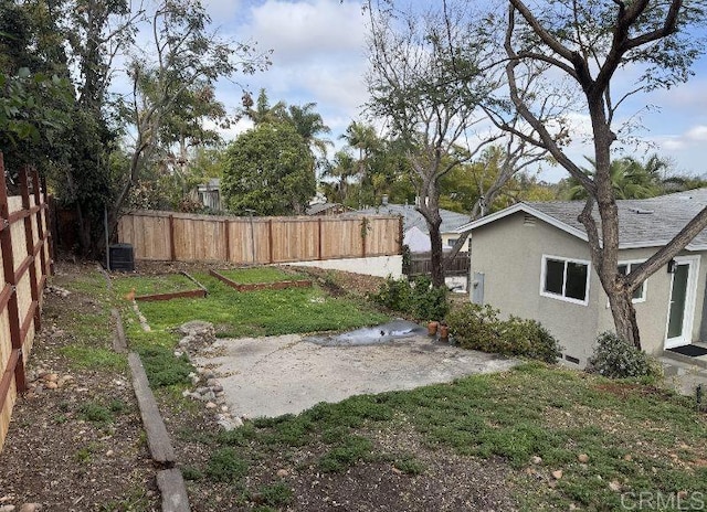 view of yard with fence private yard and central AC