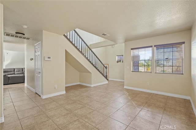 36857 42nd St E, Palmdale, CA 93552 - unfurnished room featuring baseboards, stairs, visible vents, and a textured ceiling