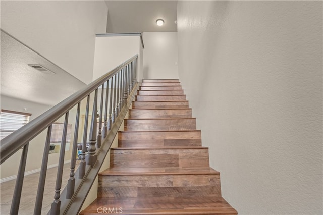 36857 42nd St E, Palmdale, CA 93552 - staircase featuring a textured wall, visible vents, and baseboards